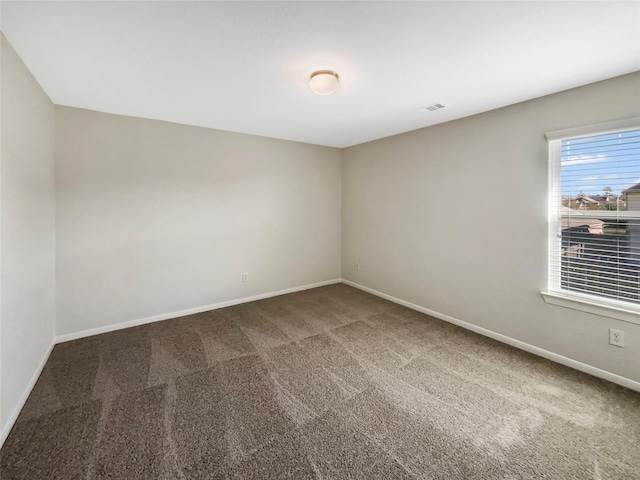 spare room with visible vents, baseboards, and carpet flooring