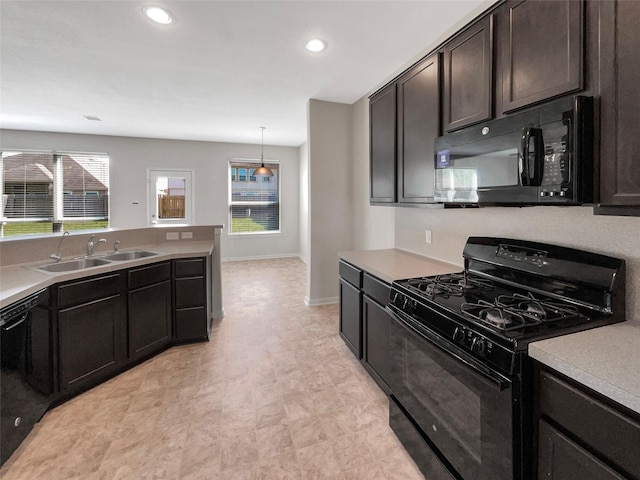 kitchen featuring a sink, baseboards, black appliances, and recessed lighting