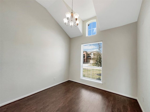 spare room with baseboards, lofted ceiling, a chandelier, and dark wood-style flooring