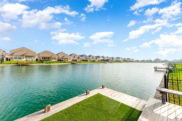 dock area with a residential view and a water view