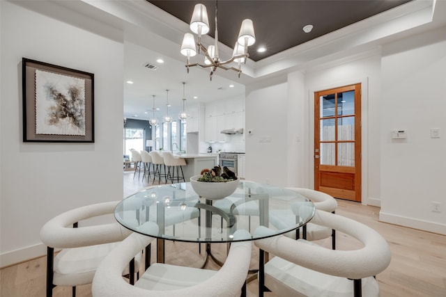 dining room with a notable chandelier, recessed lighting, light wood-type flooring, and visible vents