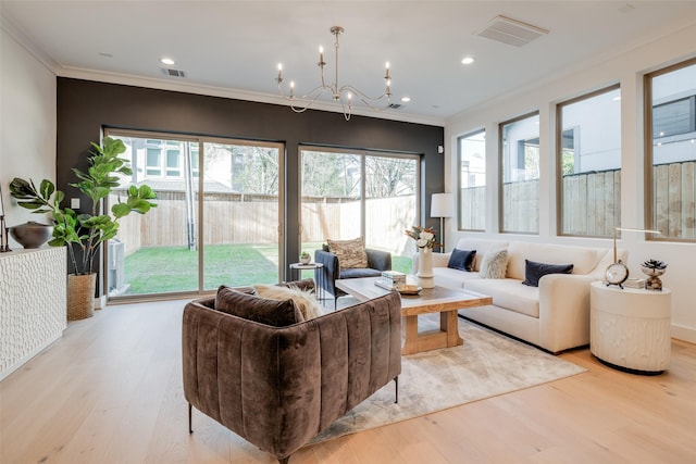 living room with visible vents, light wood finished floors, an inviting chandelier, recessed lighting, and crown molding