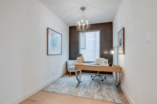 office with baseboards, an inviting chandelier, and wood finished floors