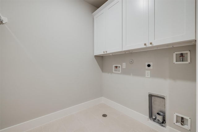 washroom with hookup for a washing machine, cabinet space, baseboards, and electric dryer hookup