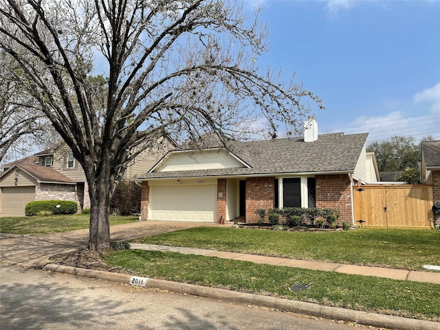 ranch-style house featuring driveway, a front yard, a shingled roof, a garage, and brick siding