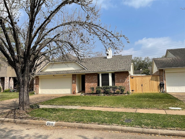 ranch-style home featuring a front lawn, a shingled roof, a garage, brick siding, and a chimney