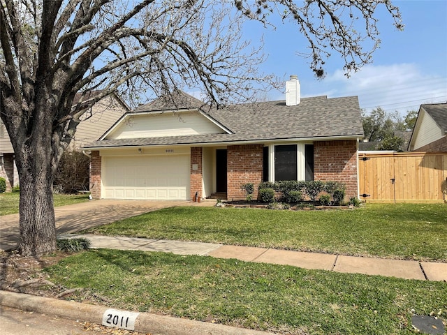 view of front of property featuring brick siding, an attached garage, driveway, and a front lawn