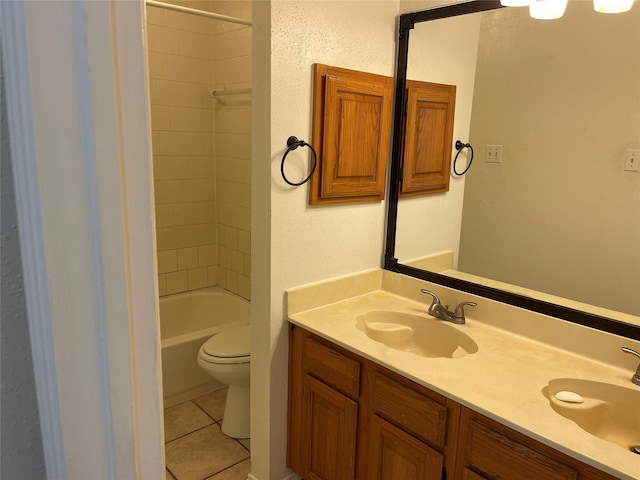 full bathroom featuring tile patterned floors, toilet, double vanity, and a sink