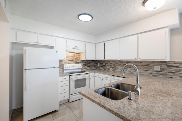 kitchen with under cabinet range hood, decorative backsplash, white appliances, white cabinetry, and a sink