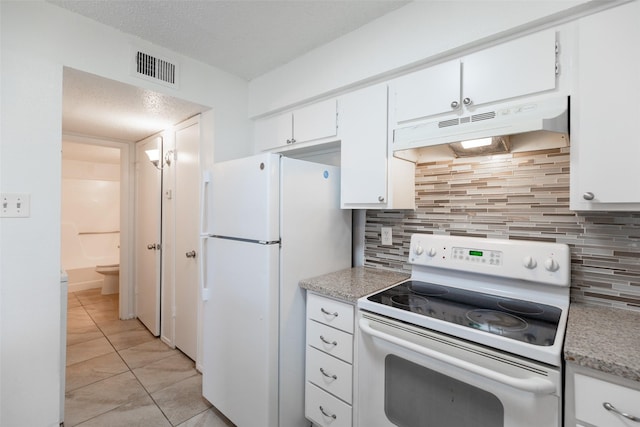 kitchen with visible vents, under cabinet range hood, light countertops, white appliances, and white cabinetry