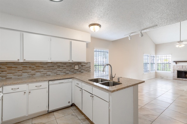 kitchen featuring tasteful backsplash, open floor plan, white dishwasher, a ceiling fan, and a sink