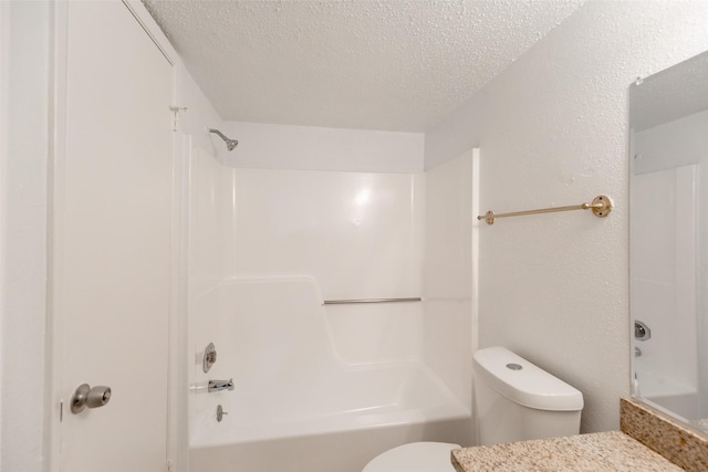 bathroom featuring shower / washtub combination, toilet, and a textured ceiling