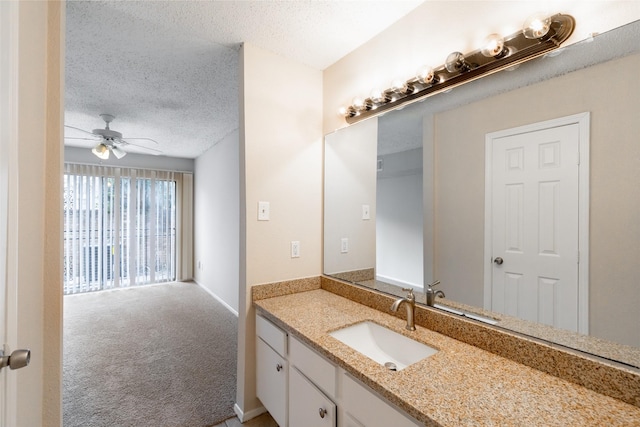 bathroom featuring vanity, a ceiling fan, and a textured ceiling