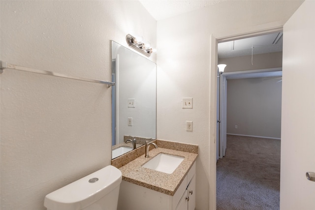 half bathroom with vanity and toilet