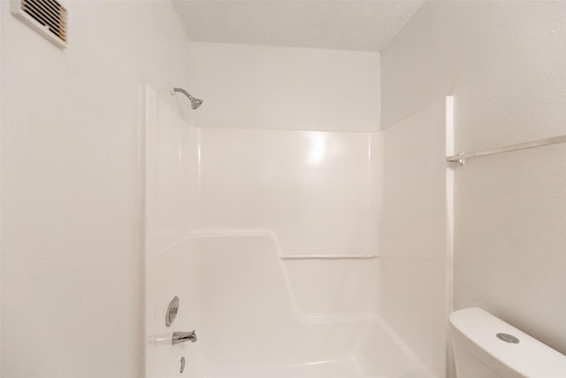 full bathroom with visible vents, a textured ceiling, and toilet