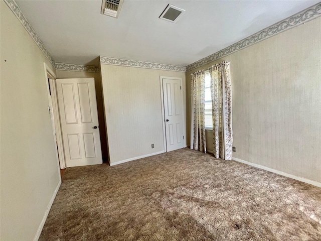 unfurnished bedroom featuring visible vents, carpet floors, and wallpapered walls