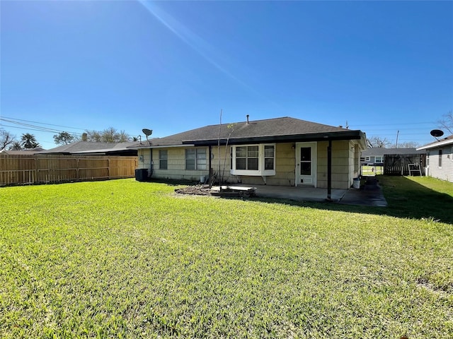 back of house with a yard, a patio, and fence