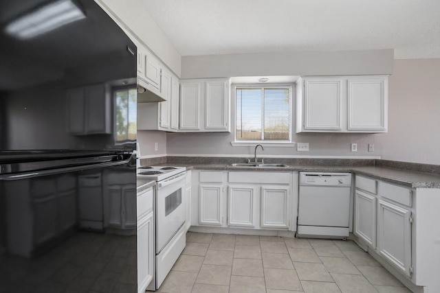 kitchen with white appliances, dark countertops, under cabinet range hood, and a sink