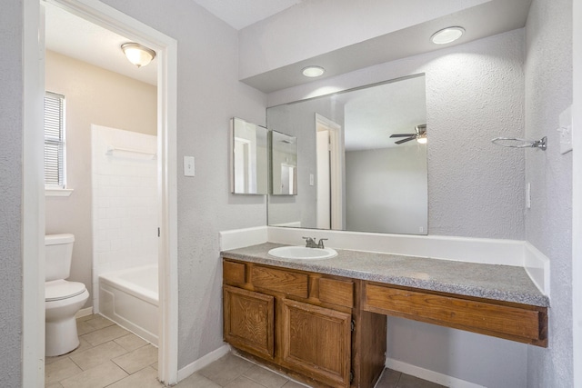 bathroom with tile patterned flooring, baseboards, ceiling fan, toilet, and vanity