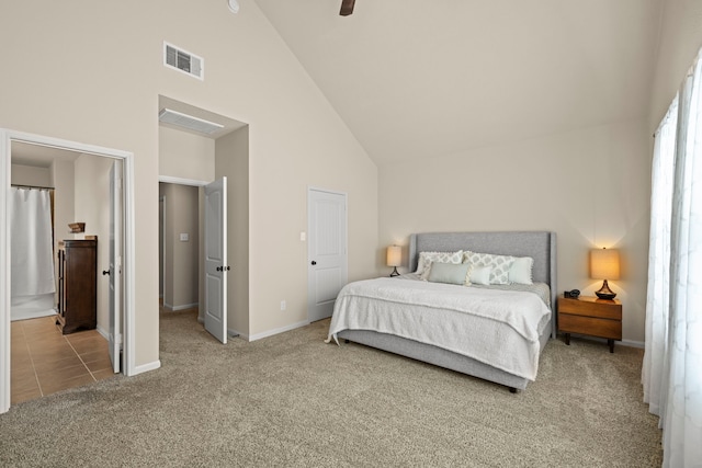 carpeted bedroom with a ceiling fan, baseboards, visible vents, high vaulted ceiling, and ensuite bathroom