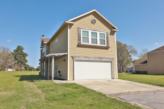 view of front facade with a garage, a chimney, concrete driveway, and a front lawn