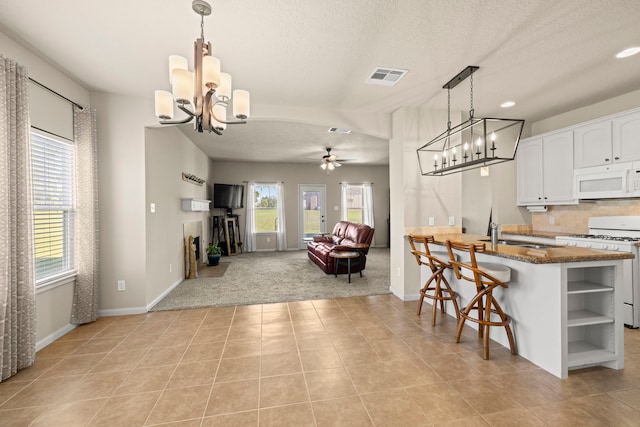 kitchen featuring white appliances, open shelves, a sink, white cabinetry, and ceiling fan with notable chandelier