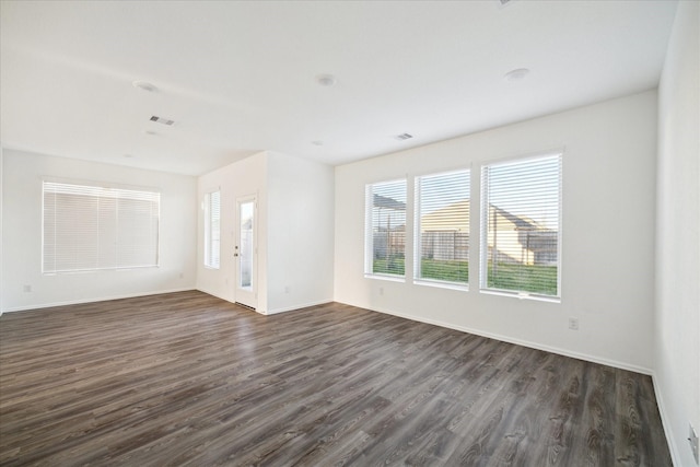 interior space with dark wood finished floors, baseboards, and visible vents