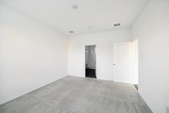 empty room featuring visible vents and carpet flooring