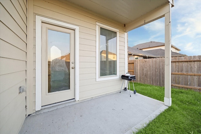 view of patio / terrace featuring fence and a grill