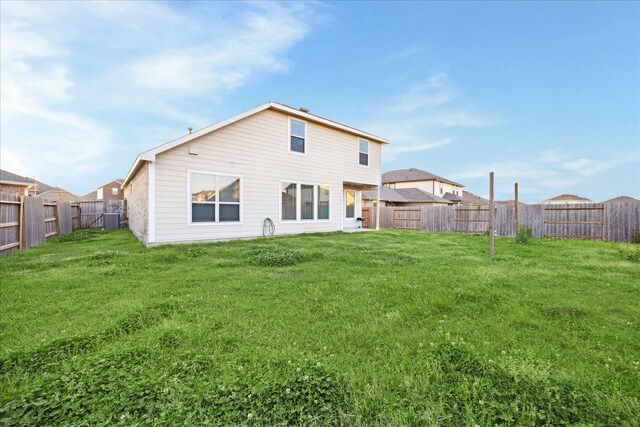 rear view of house featuring a yard, a fenced backyard, and cooling unit