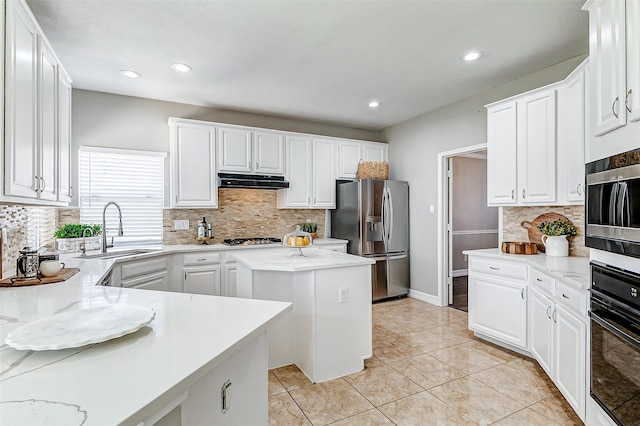 kitchen featuring light tile patterned flooring, a sink, stainless steel appliances, white cabinets, and under cabinet range hood