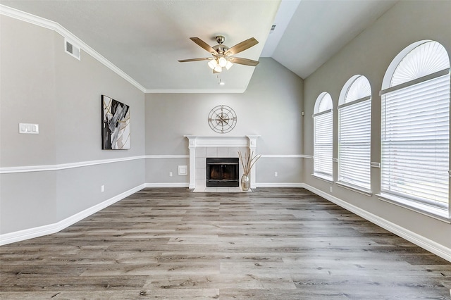 unfurnished living room with visible vents, wood finished floors, a fireplace, lofted ceiling, and ceiling fan