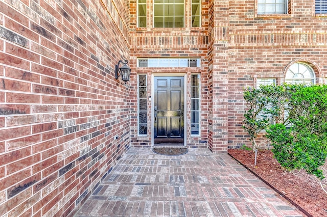 entrance to property with brick siding