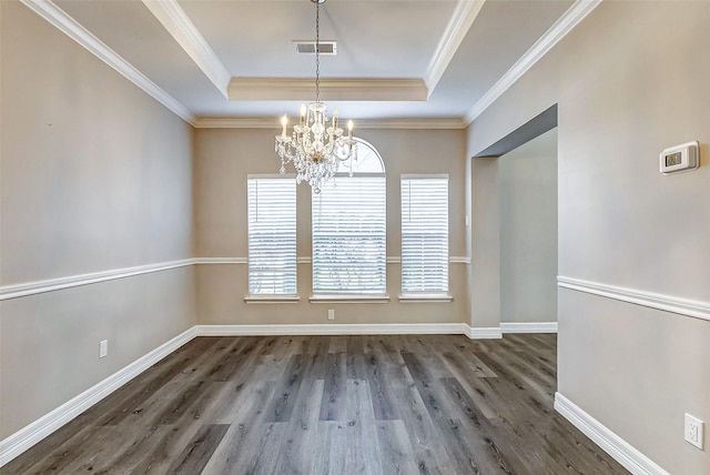 unfurnished dining area featuring visible vents, baseboards, a chandelier, wood finished floors, and a raised ceiling