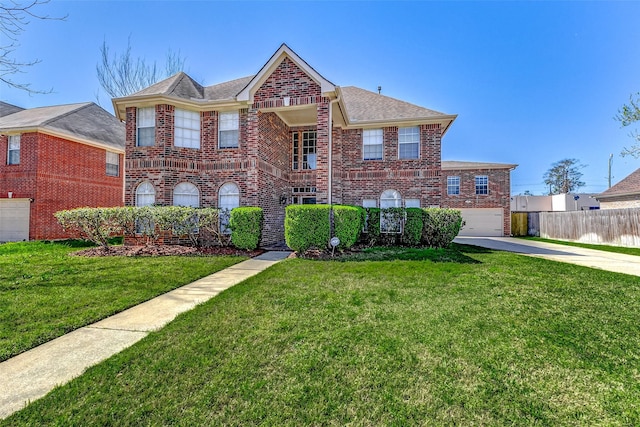 traditional-style home featuring brick siding, driveway, a front yard, and fence