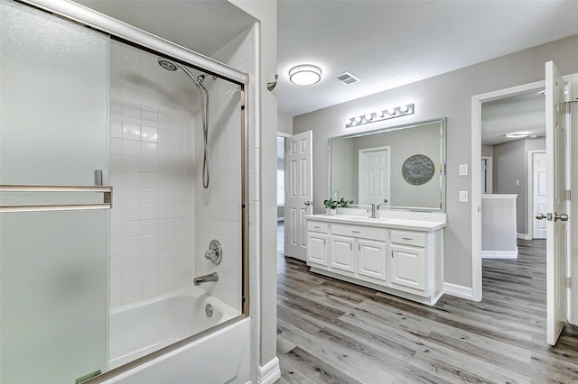 full bath featuring visible vents, bathing tub / shower combination, wood finished floors, and vanity