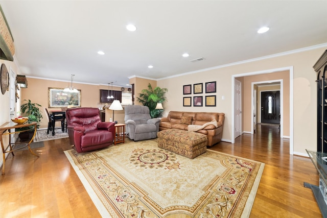 living room featuring visible vents, recessed lighting, wood finished floors, and ornamental molding