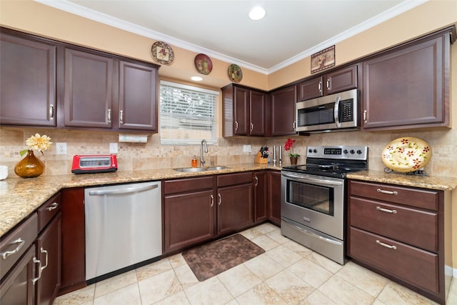 kitchen with backsplash, ornamental molding, stainless steel appliances, and a sink