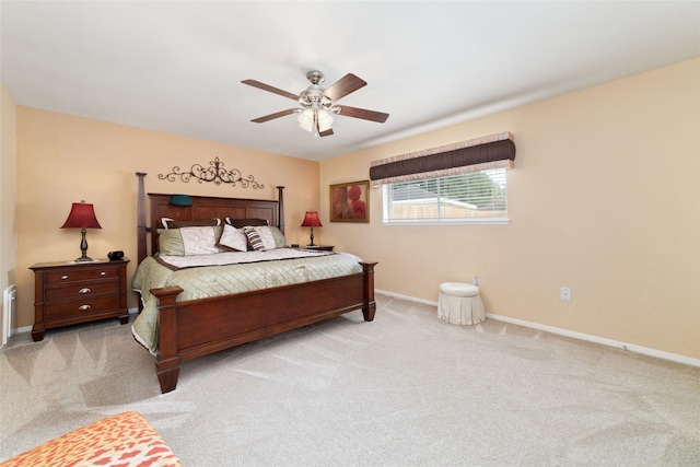 bedroom featuring baseboards, light colored carpet, and ceiling fan