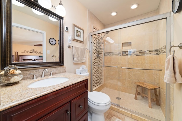 full bathroom featuring vanity, a shower stall, toilet, and tile patterned floors