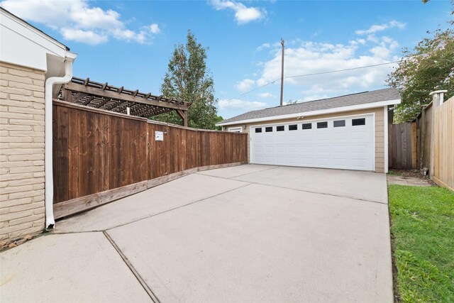 detached garage featuring fence