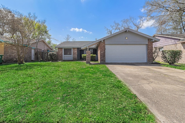 view of front facade with brick siding, an attached garage, concrete driveway, and a front yard