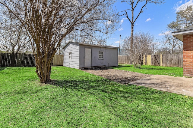 view of yard with an outdoor structure and a fenced backyard