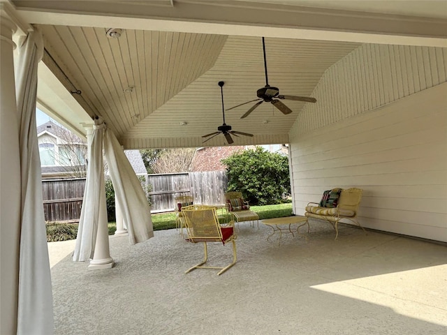 view of patio / terrace featuring ceiling fan and fence