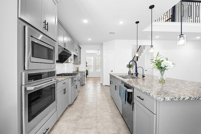 kitchen featuring a sink, gray cabinetry, and stainless steel appliances