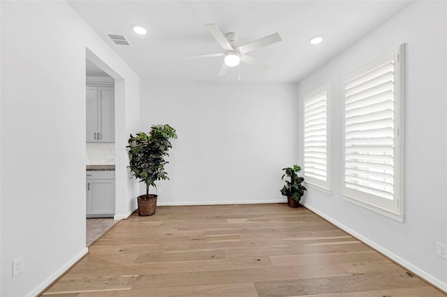 spare room featuring recessed lighting, baseboards, light wood-style floors, and a ceiling fan