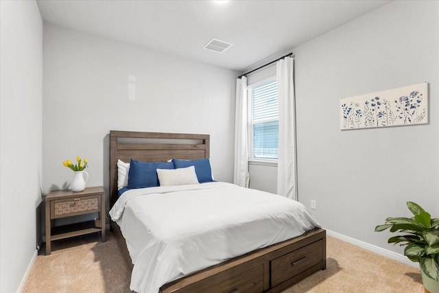 bedroom featuring light carpet, visible vents, and baseboards