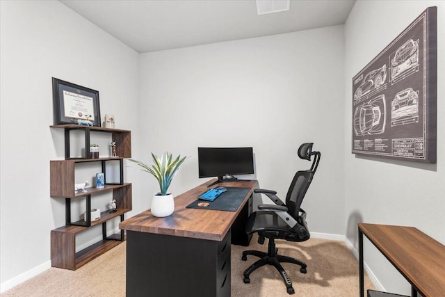 home office featuring light colored carpet, visible vents, and baseboards