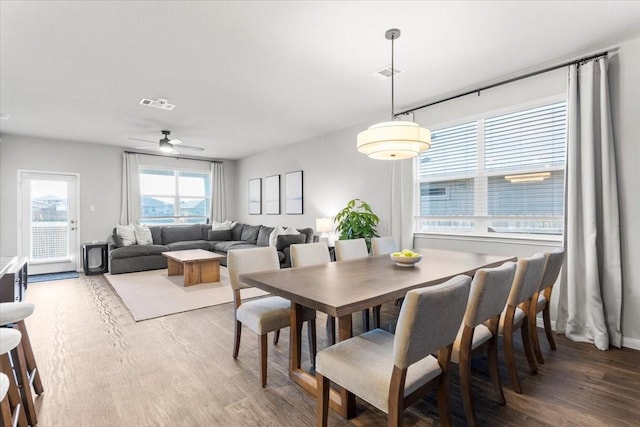 dining space featuring a ceiling fan, wood finished floors, and visible vents