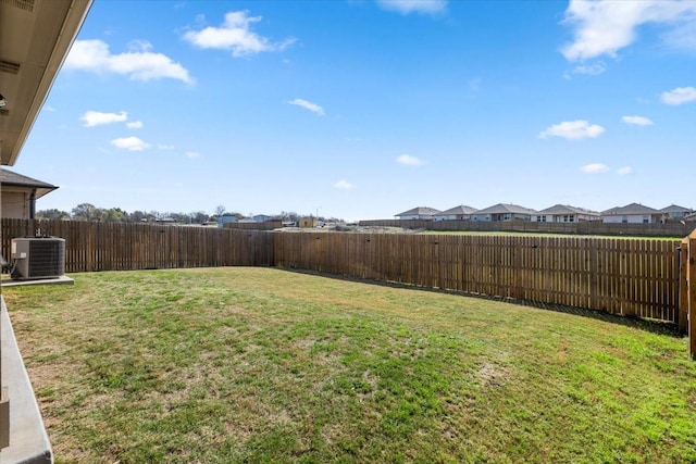 view of yard featuring central AC unit and a fenced backyard